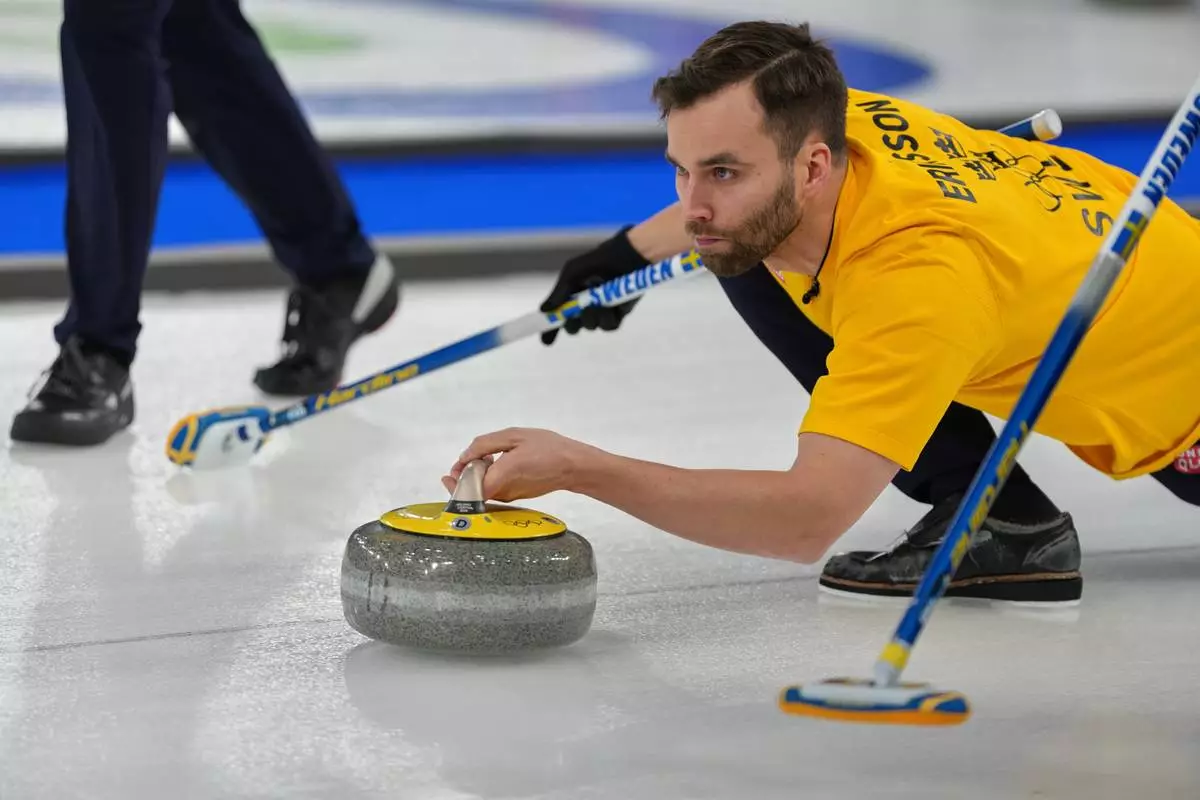 Sweden's Oskar Eriksson in action during the men's curling round robin session against Canada, at the 2026 Winter Olympics, in Cortina d'Ampezzo, Italy, Friday, Feb. 13, 2026. (AP Photo/Misper Apawu)