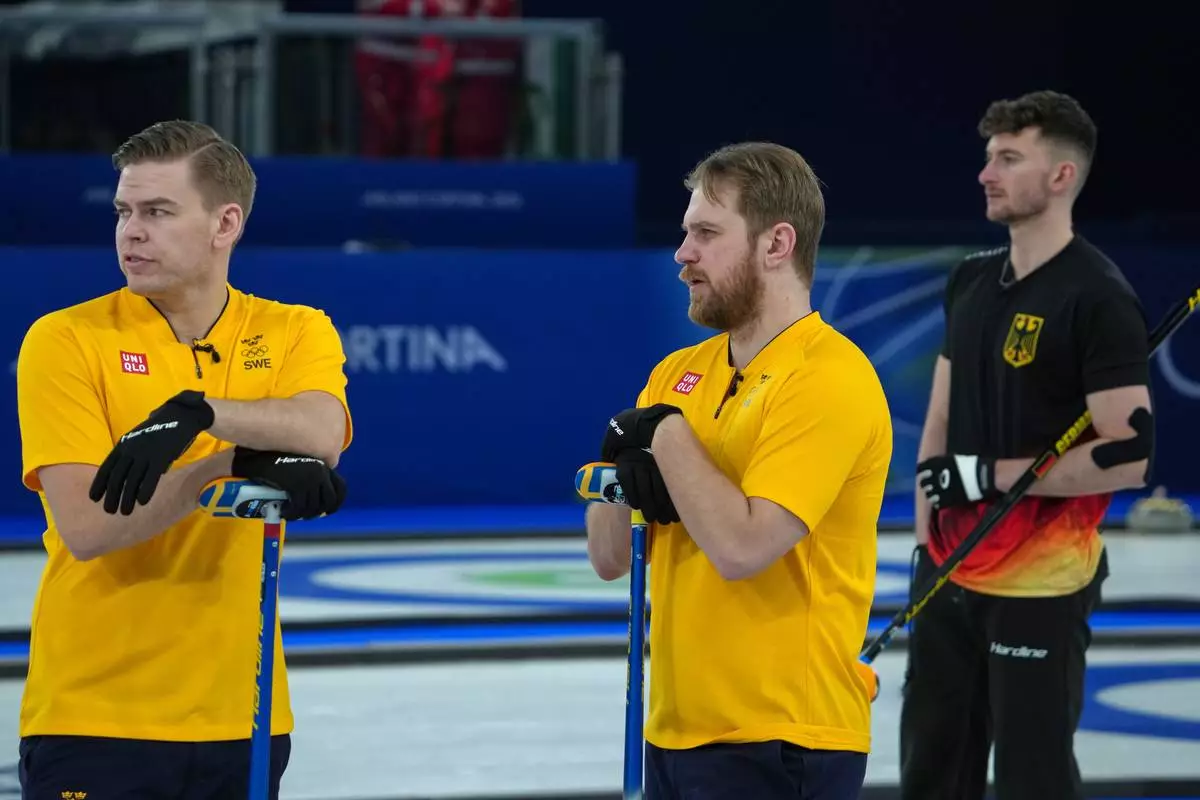 Sweden's Rasmus Wranaa and Christoffer Sundgren look on during the men's curling round robin session against Canada, at the 2026 Winter Olympics, in Cortina d'Ampezzo, Italy, Friday, Feb. 13, 2026. (AP Photo/Misper Apawu)