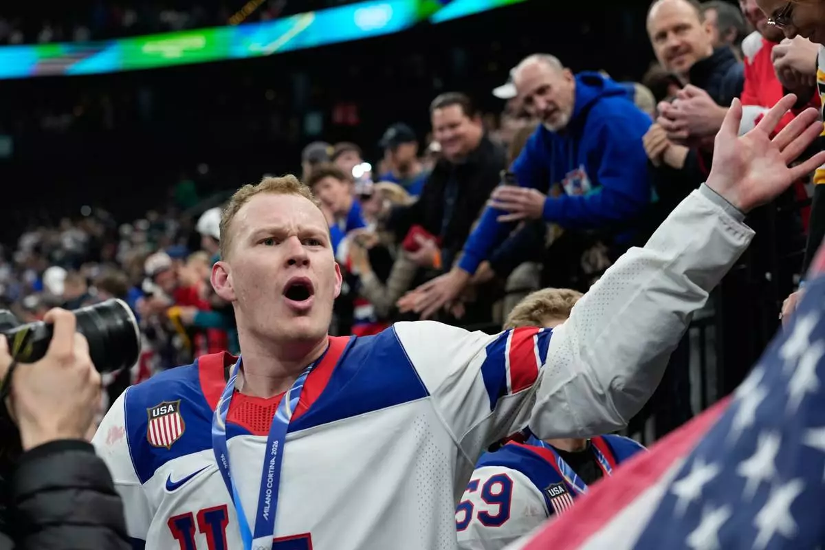 United States' Brady Tkachuk (7) celebrates after the United States defeated Canada in a men's ice hockey gold medal game between Canada and the United States at the 2026 Winter Olympics, in Milan, Italy, Sunday, Feb. 22, 2026. (AP Photo/Petr David Josek)