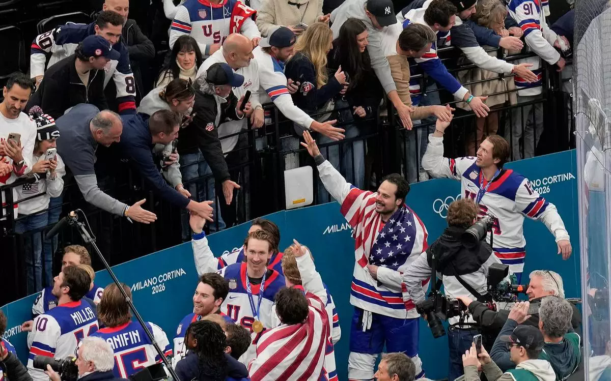 United States players greet fans after defeating Canada in the men's ice hockey gold medal game at the 2026 Winter Olympics, in Milan, Italy, Sunday, Feb. 22, 2026. (AP Photo/Luca Bruno)