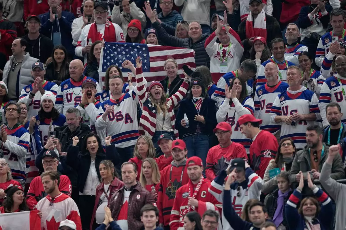 United States fans cheer after a men's ice hockey gold medal game between Canada and the United States at the 2026 Winter Olympics, in Milan, Italy, Sunday, Feb. 22, 2026. (AP Photo/Petr David Josek)