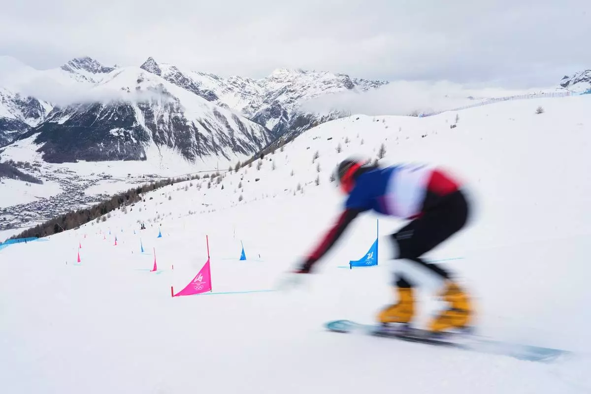 Bulgaria's Alexander Krashniak practices during a snowboard parallel giant slalom training session at the 2026 Winter Olympics, in Livigno, Italy, Friday, Feb. 6, 2026. (AP Photo/Gregory Bull)