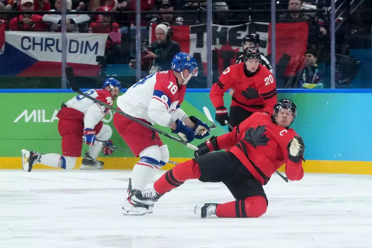 Czechia's Ondrej Palat (18) checks Canada's Sidney Crosby (87) during the second period of a men's ice hockey quarterfinal game at the 2026 Winter Olympics, in Milan, Italy, Wednesday, Feb. 18, 2026. (Darryl Dyck/The Canadian Press via AP)