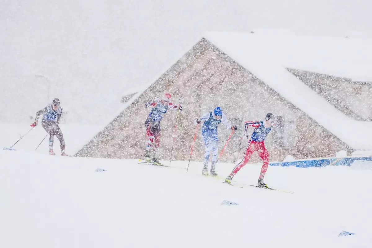 Jens Luraas Oftebro, of Norway, from right, Eero Hirvonen, of Finland and Johannes Lamparter, of Austria, compete in the nordic combined team sprint at the 2026 Winter Olympics, in Tesero, Italy, Thursday, Feb. 19, 2026. (AP Photo/Kirsty Wigglesworth)