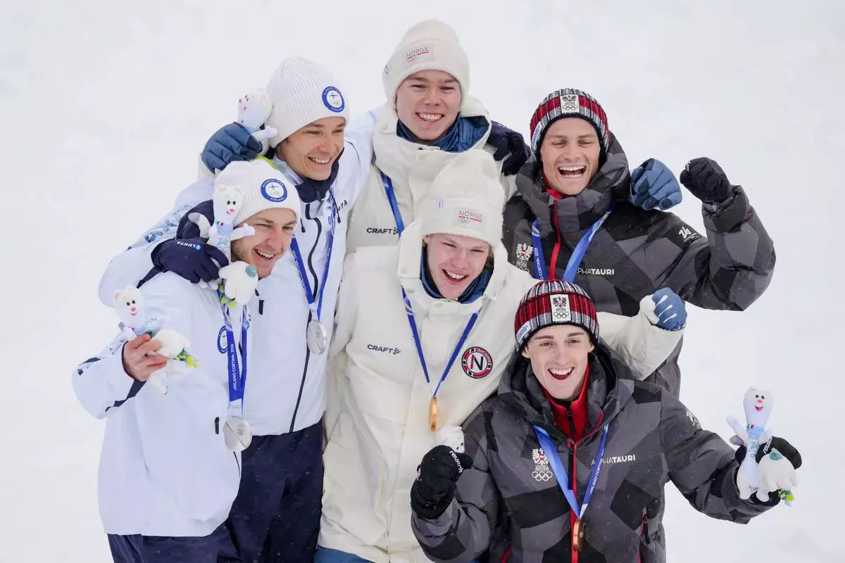 Silver medalists Eero Hirvonen and Ilkka Herola, of Finland, gold medalists Andreas Skoglund and Jens Luraas Oftebro, of Norway, and bronze medalists Stefan Rettenegger and Johannes Lamparter, of Austria, pose after finishing the nordic combined team sprint at the 2026 Winter Olympics, in Tesero, Italy, Thursday, Feb. 19, 2026. (AP Photo/Evgeniy Maloletka)