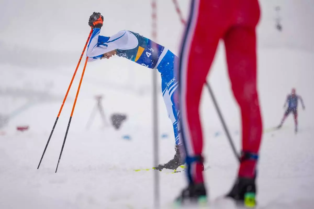 Eero Hirvonen, of Finland, reacts after crossing the finish line to win the silver medal in the nordic combined team sprint at the 2026 Winter Olympics, in Tesero, Italy, Thursday, Feb. 19, 2026. (AP Photo/Matthias Schrader)