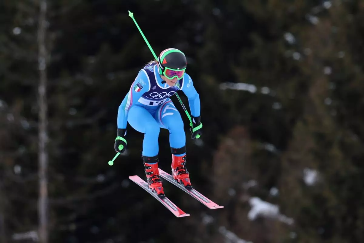 Italy's Sofia Goggia speeds down the course during an alpine ski, women's downhill official training, at the 2026 Winter Olympics, in Cortina d'Ampezzo, Italy, Friday, Feb. 6, 2026. (AP Photo/Marco Trovati)