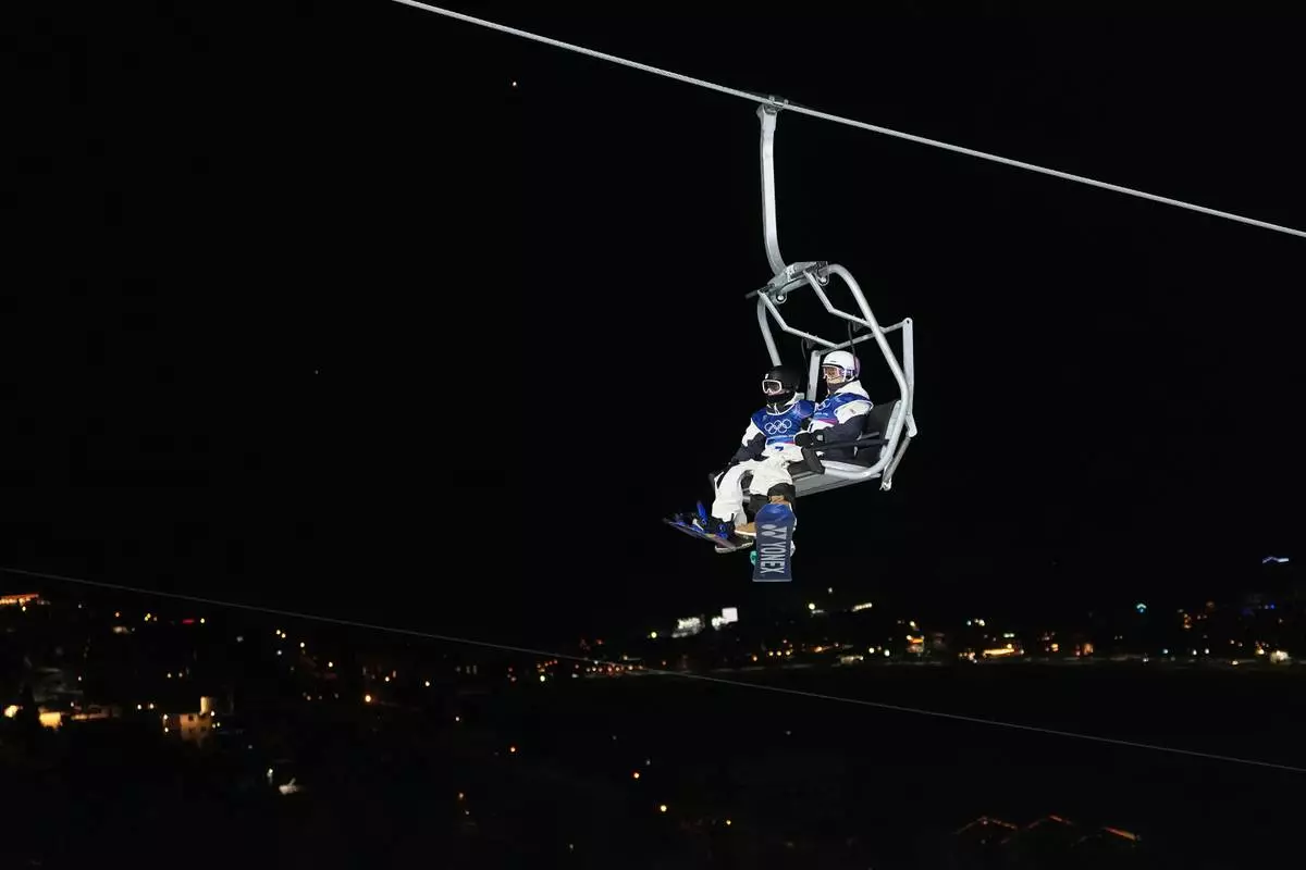 Japan's Ryusei Yamada, left, and Japan's Yuto Totsuka ride a chair lift during a snowboard halfpipe training session at the 2026 Winter Olympics, in Livigno, Italy, Sunday, Feb. 8, 2026. (AP Photo/Lindsey Wasson)