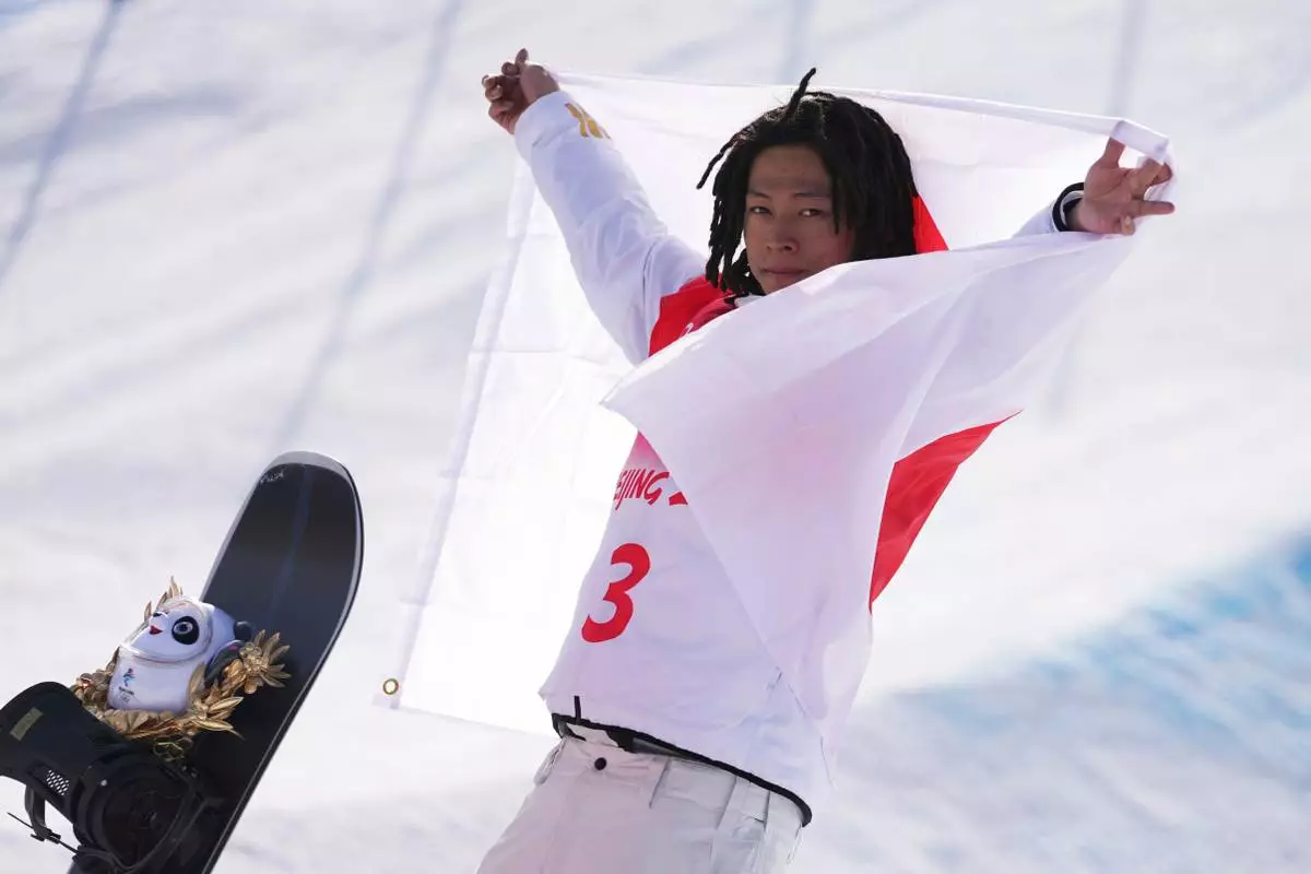 FILE - Gold medal winner Japan's Ayumu Hirano celebrates during the venue award ceremony for the men's halfpipe finals at the 2022 Winter Olympics, Friday, Feb. 11, 2022, in Zhangjiakou, China. (AP Photo/Matthias Schrader, File)