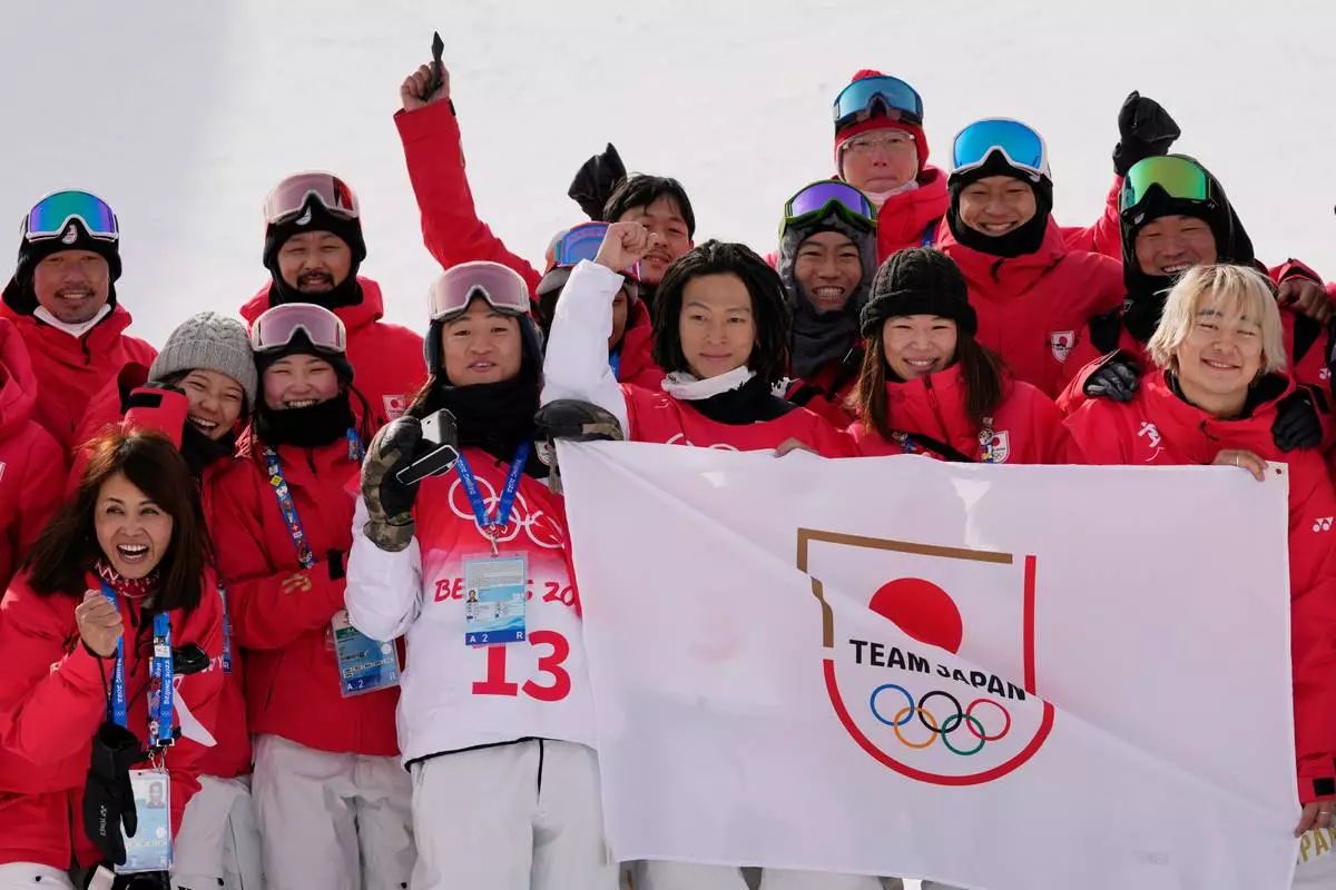 FILE - Japan's Ayumu Hirano poses for pictures after winning a gold medal in the men's halfpipe finals at the 2022 Winter Olympics, Friday, Feb. 11, 2022, in Zhangjiakou, China. (AP Photo/Francisco Seco, File)