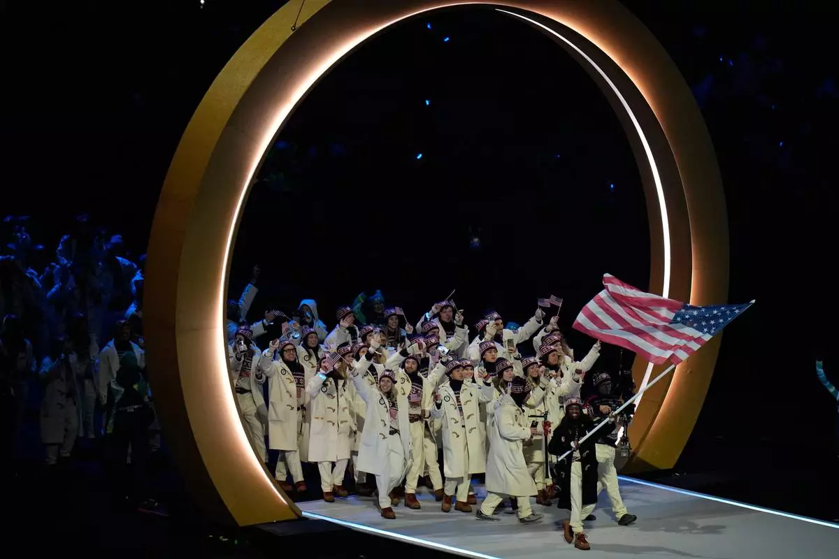 United States' flag barer Erin Jackson arrives during the Olympic opening ceremony at the 2026 Winter Olympics, in Milan, Italy, Friday, Feb. 6, 2026. (AP Photo/Hassan Ammar)