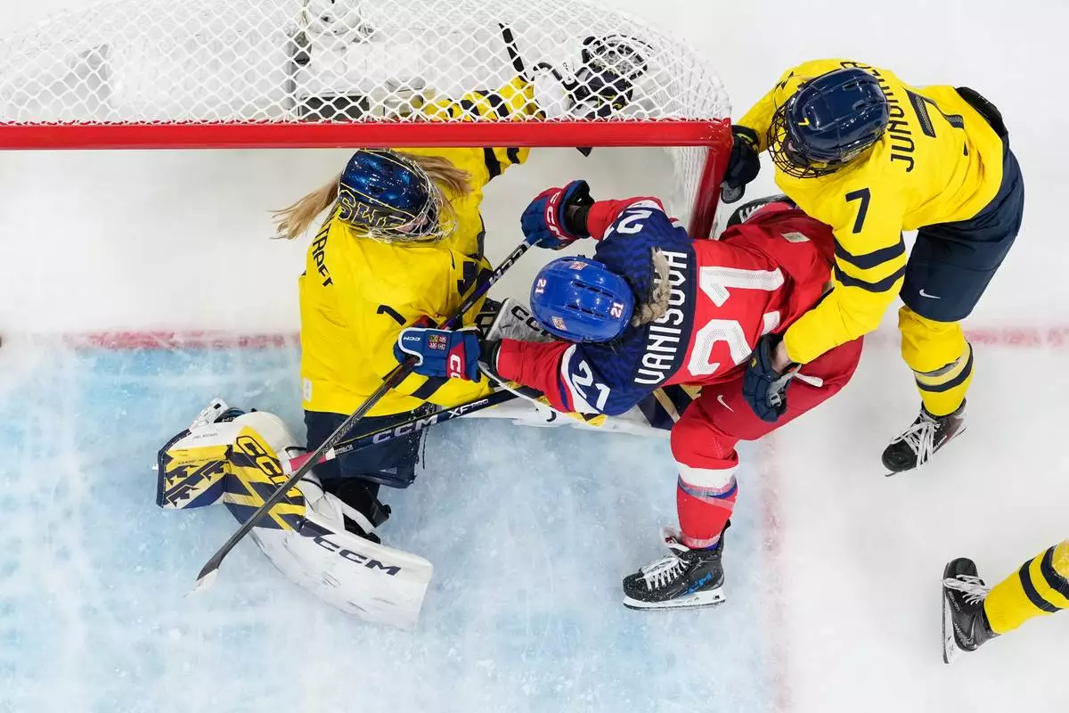 Czechia's Tereza Vanisova (21) challenges with Sweden's Ebba Svensson Traff (1) during a women's quarterfinal game between Czechia and Sweden at the 2026 Winter Olympics, in Milan, Italy, Friday, Feb. 13, 2026. (AP Photo/Darko Bandic)