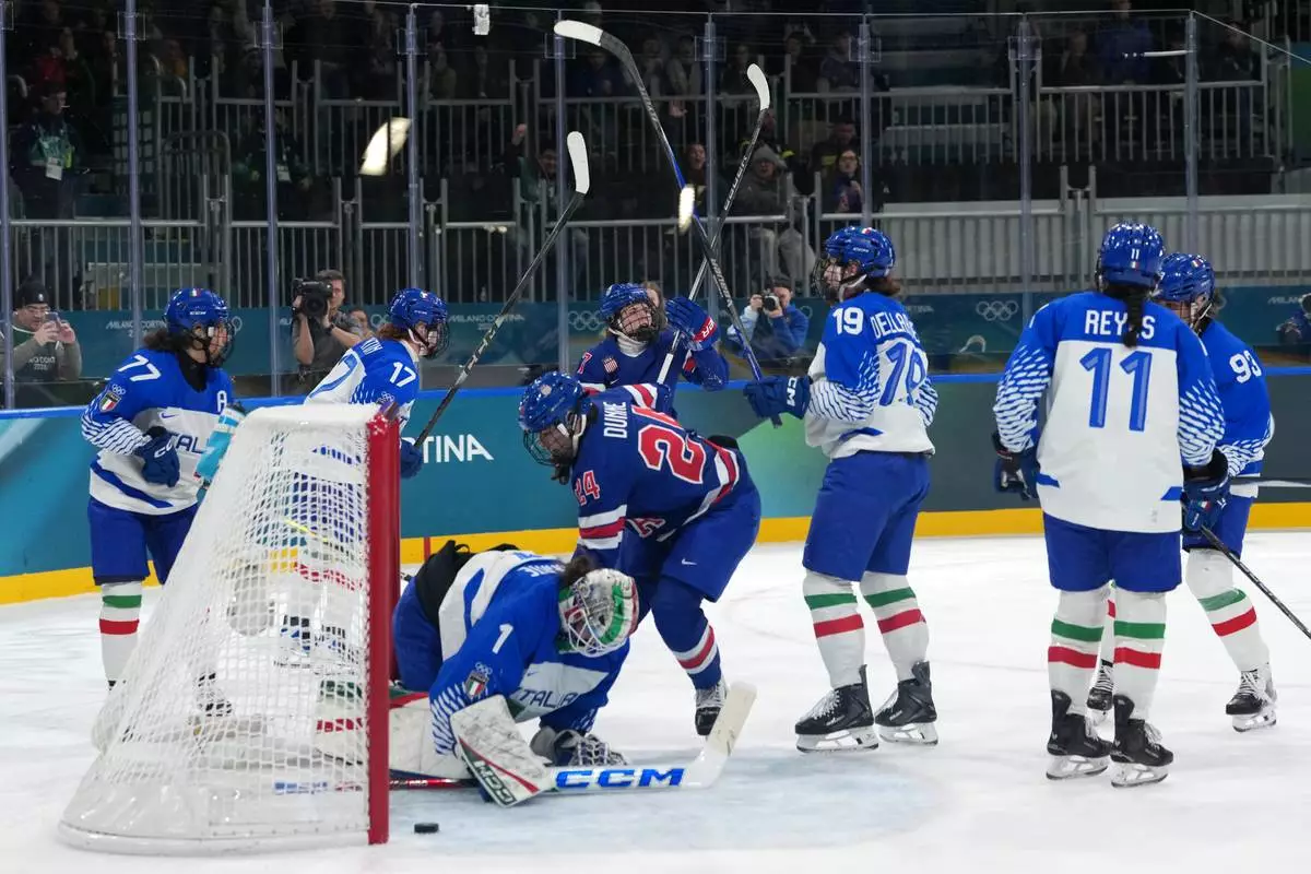 Team United States players celebrate after a goal by Britta Curl, center top, during the second period of a women's ice hockey quarterfinal match between the United States and Italy at the 2026 Winter Olympics, in Milan, Italy, Friday, Feb. 13, 2026. (AP Photo/Carolyn Kaster)