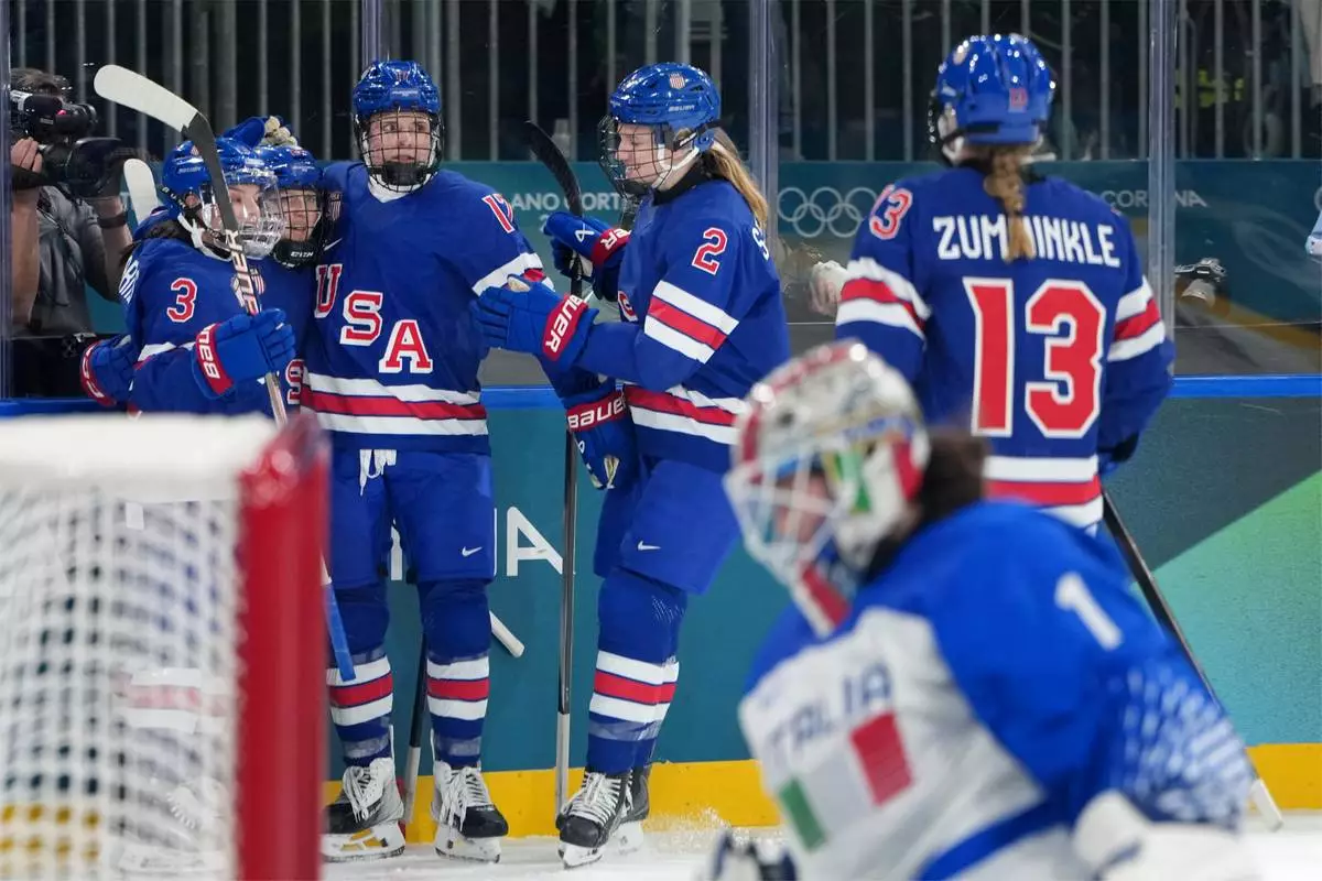 Team United States players celebrate a goal by Kendall Coyne, second from left, during the second period of a women's ice hockey quarterfinal match against Italy at the 2026 Winter Olympics, in Milan, Italy, Friday, Feb. 13, 2026. (AP Photo/Carolyn Kaster)