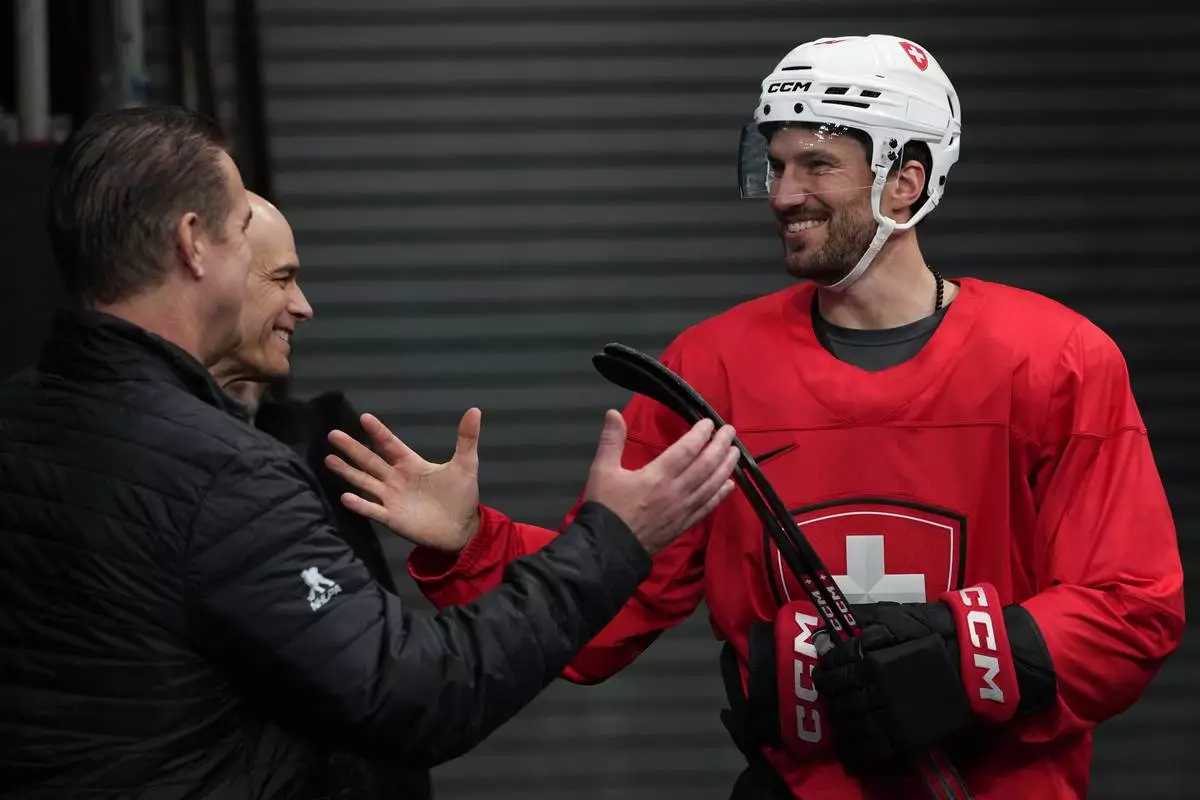 Switzerland's Roman Josi arrives for men's ice hockey practice at the 2026 Winter Olympics, in Milan, Italy, Sunday, Feb. 8, 2026. (AP Photo/Carolyn Kaster)