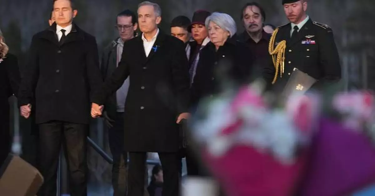 Prime Minister Carney and Canada's main opposition leader hold hands during school shooting vigil
