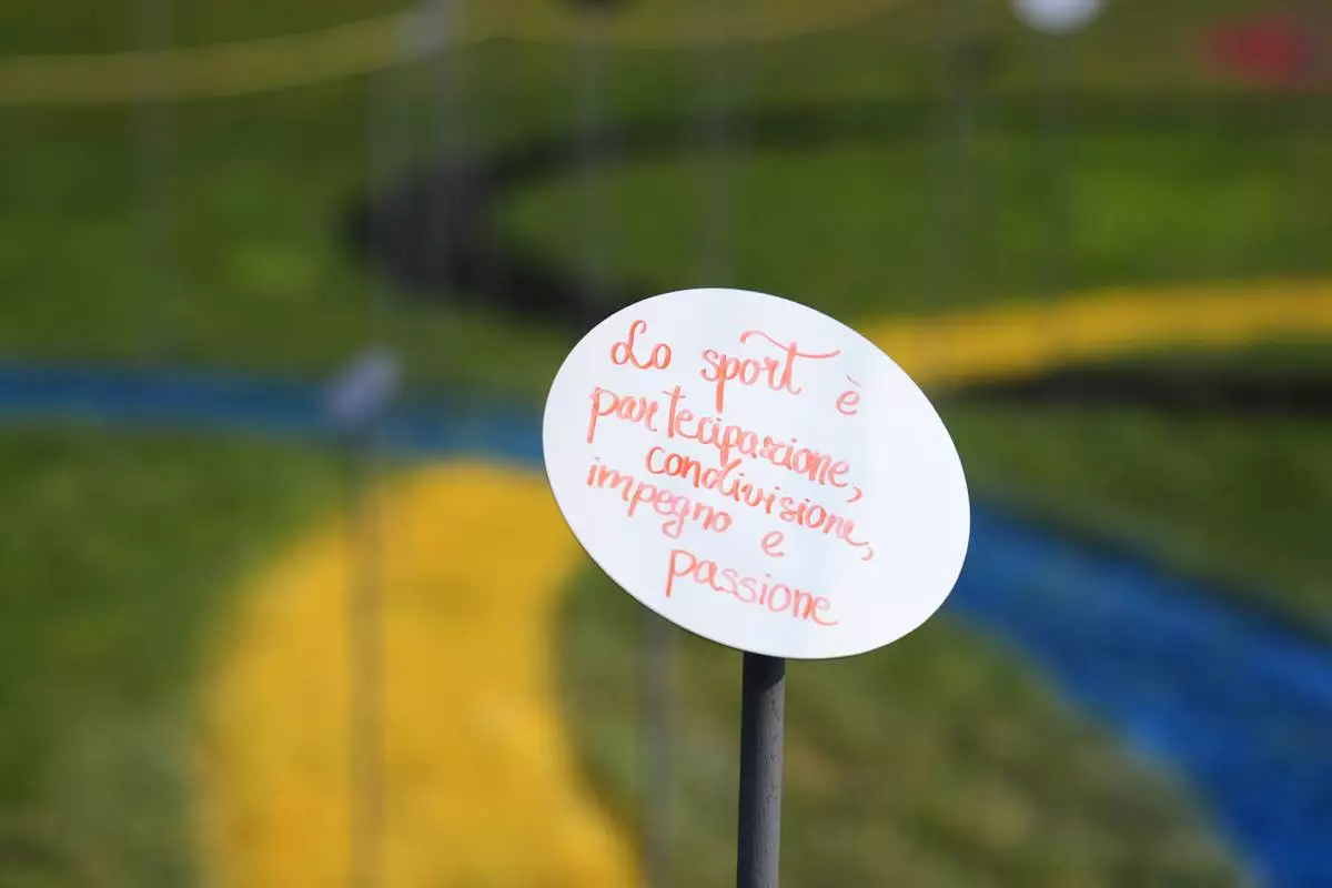 A view of a mirrored flower bearing a handwritten message as part of “Together to Reflect,” an interactive community art project by BAM, the acronym for Biblioteca degli Alberi Milano, a public park in central Milan inviting the public to share thoughts on the values of sport, during the 2026 Winter Olympics, in Milan, Italy, Sunday, Feb. 8, 2026. (AP Photo/María Teresa Hernández)