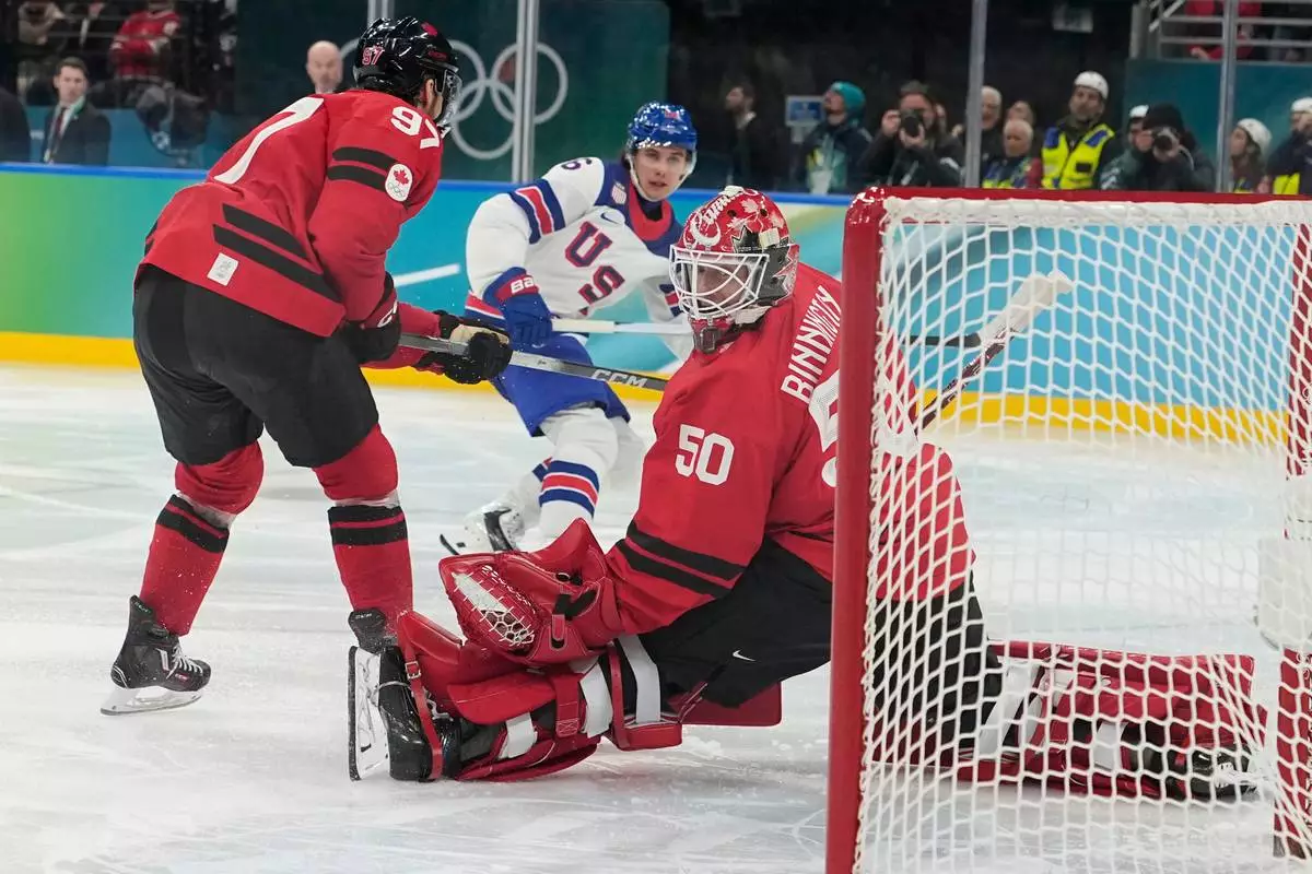 United States' Jack Hughes (86) scores during a men's ice hockey gold medal game between Canada and the United States at the 2026 Winter Olympics, in Milan, Italy, Sunday, Feb. 22, 2026. (AP Photo/Hassan Ammar)