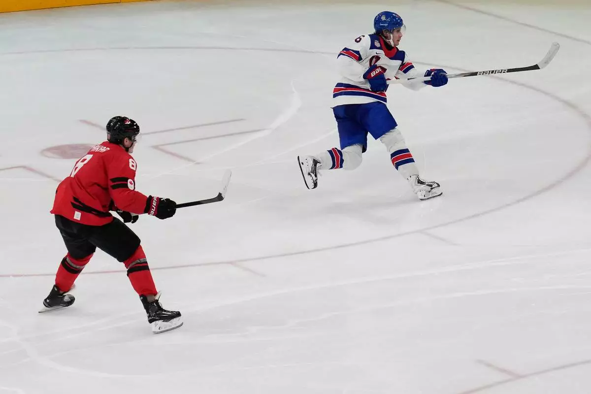 United States' Jack Hughes (86) takes a shot to score the winning goal in sudden death overtime against Canada during the men's ice hockey gold medal game at the 2026 Winter Olympics, in Milan, Italy, Sunday, Feb. 22, 2026. (AP Photo/Luca Bruno)
