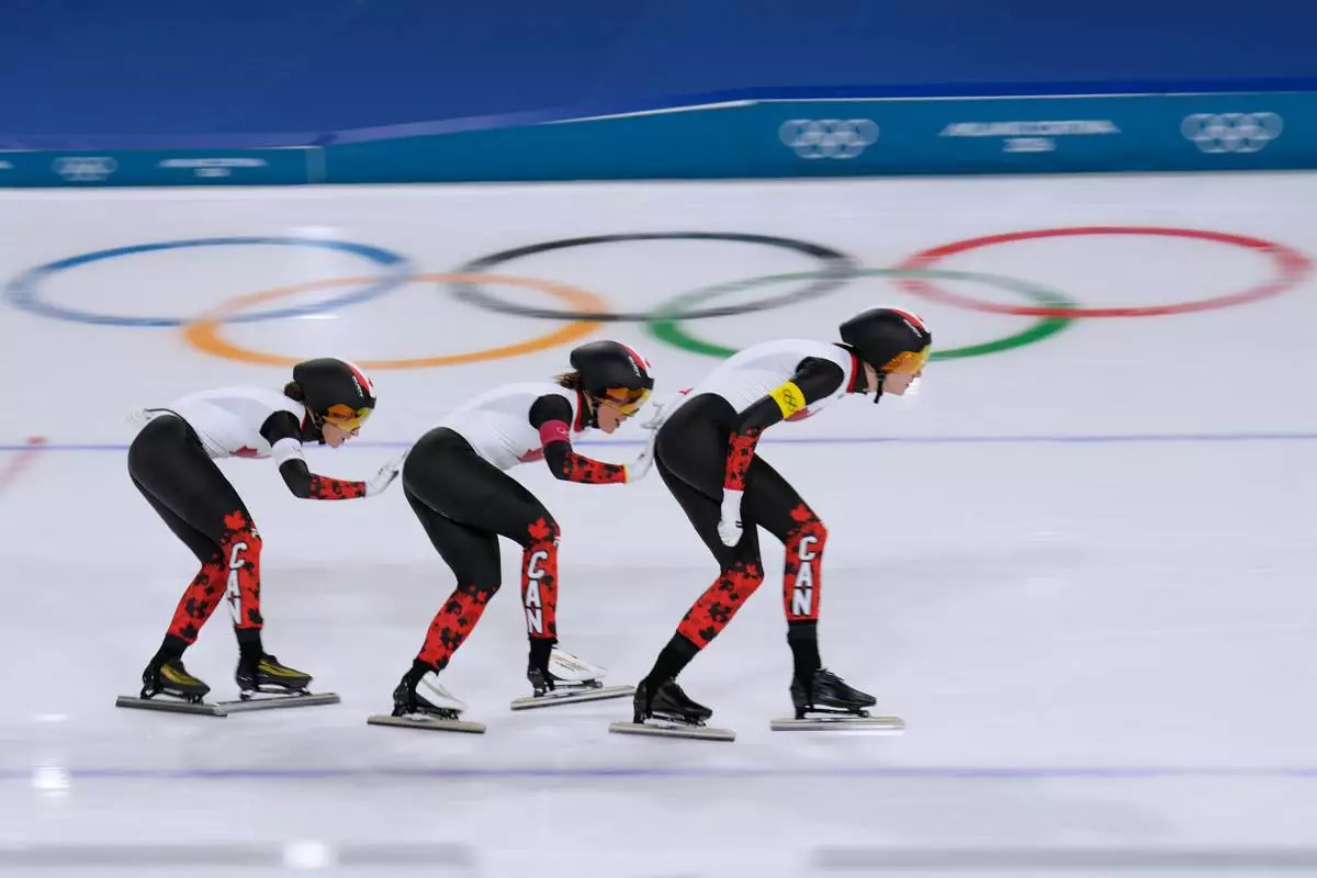 Team Canada with Ivanie Blondin, white armband, Valerie Maltais, red armband, Isabelle Weidemann, yellow armband, competes in the semifinal of the women's team pursuit speedskating race at the 2026 Winter Olympics, in Milan, Italy, Tuesday, Feb. 17, 2026. (AP Photo/Luca Bruno)