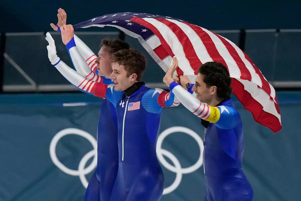 Team USA celebrate winning the silver medal in the final of the men's team pursuit speedskating race at the 2026 Winter Olympics, in Milan, Italy, Tuesday, Feb. 17, 2026. (AP Photo/Luca Bruno)