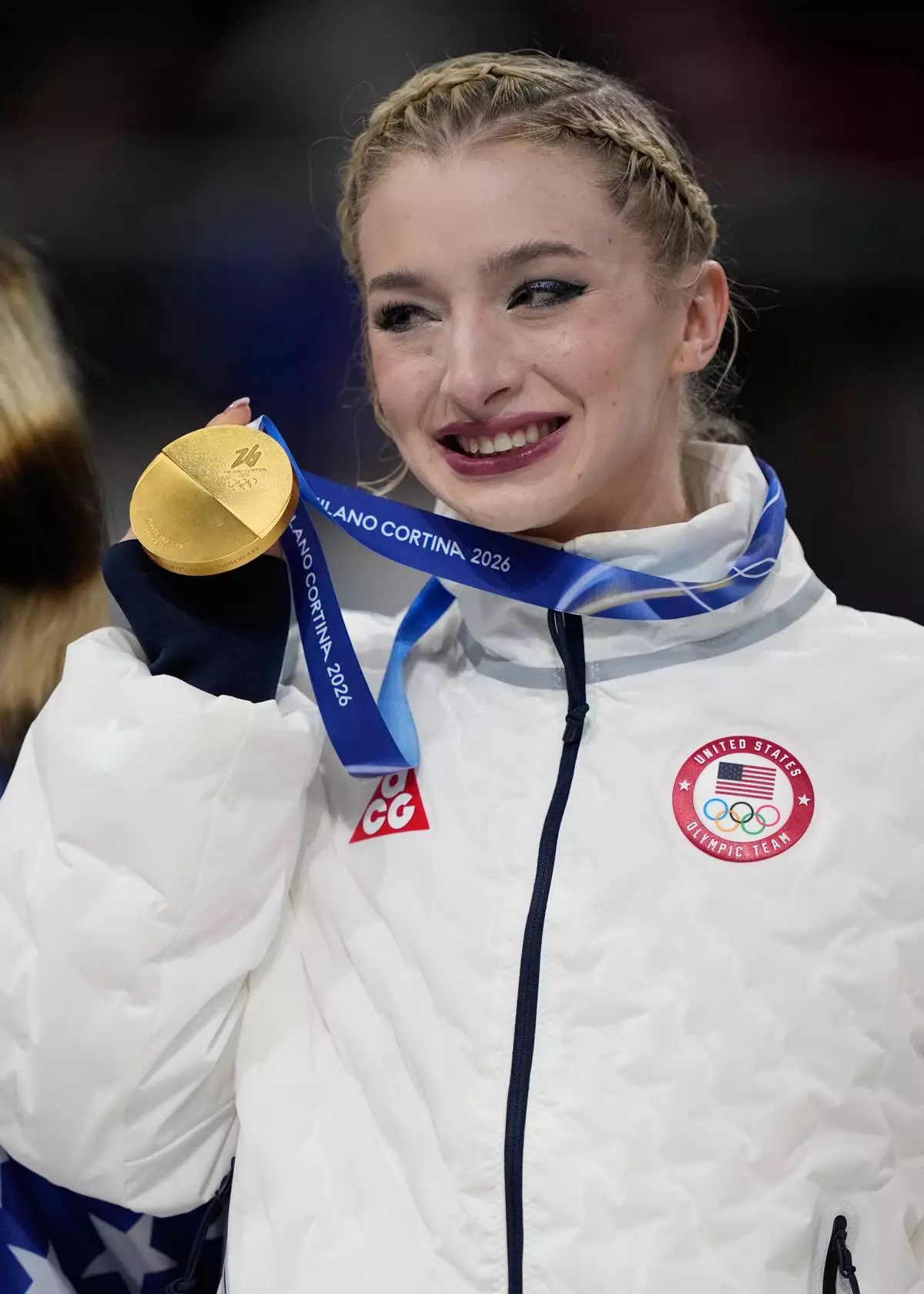 Team USA's Amber Glenn celebrates with her gold medal after the figure skating team event at the 2026 Winter Olympics, in Milan, Italy, Sunday, Feb. 8, 2026. (AP Photo/Ashley Landis)