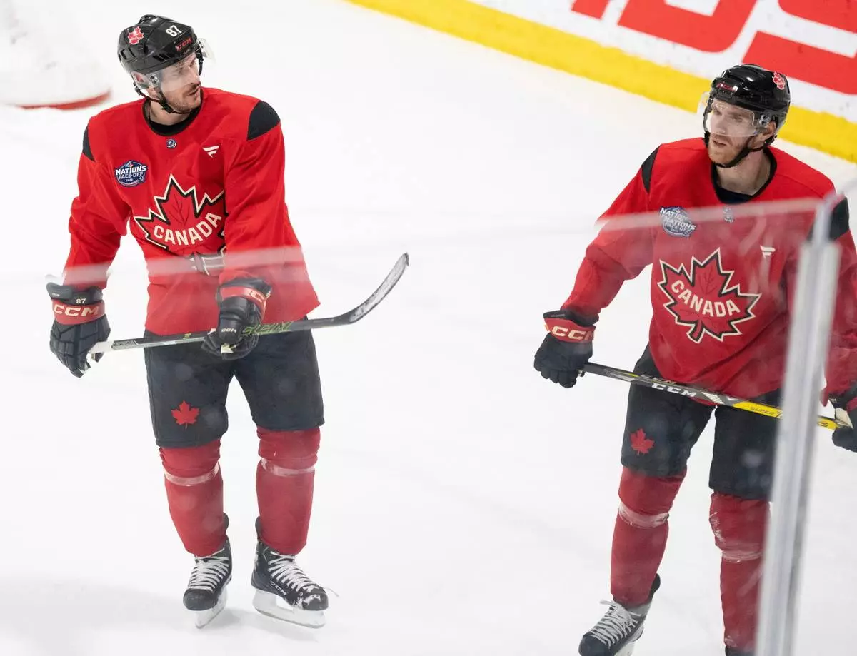 FILE - Canada's Sidney Crosby and Connor McDavid skate together following 4 Nations Face-Off hockey practice in Brossard, Quebec on Monday, Feb. 10, 2025. Canada will face Sweden on February 12. (Christinne Muschi/The Canadian Press via AP, File)