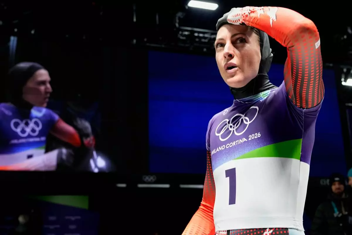 Austria's Janine Flock arrives at the finish during a women's skeleton run at the 2026 Winter Olympics, in Cortina d'Ampezzo, Italy, Friday, Feb. 13, 2026. (AP Photo/Alessandra Tarantino)
