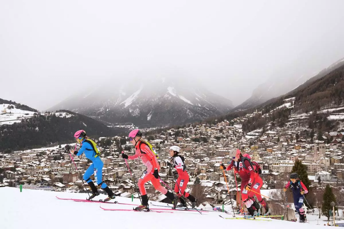 Italy's Alba de Silvestro, left, is followed by Austria's Johanna Hiemer, during a ski mountaineering mixed relay, at the 2026 Winter Olympics, in Bormio, Italy, Saturday, Feb. 21, 2026. (AP Photo/Rebecca Blackwell)