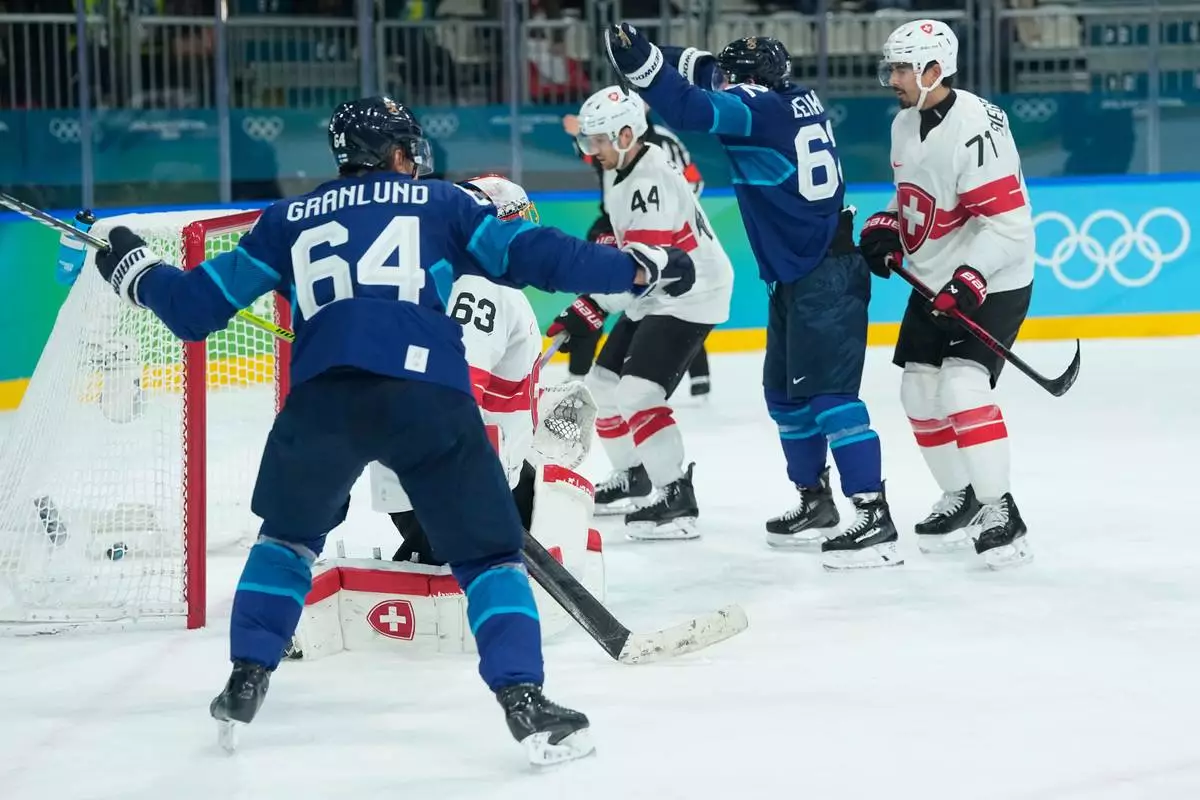 Switzerland's Leonardo Genoni (63) concedes the second goal during a men's ice hockey quarterfinal game between Finland and Switzerland at the 2026 Winter Olympics, in Milan, Italy, Wednesday, Feb. 18, 2026. (AP Photo/Petr David Josek)