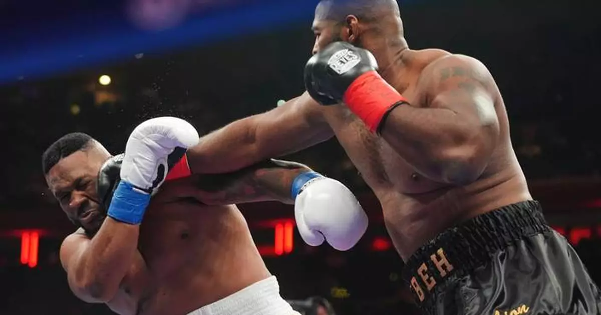Boxer Jarrell Miller has his hairpiece knocked upward by a punch, then throws it into the crowd