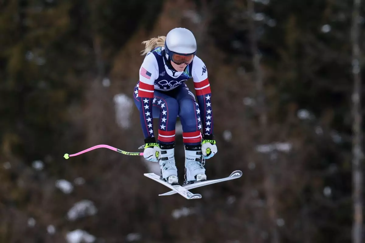 United States' Lindsey Vonn speeds down the course during an alpine ski, women's downhill official training, at the 2026 Winter Olympics, in Cortina d'Ampezzo, Italy, Friday, Feb. 6, 2026. (AP Photo/Marco Trovati)