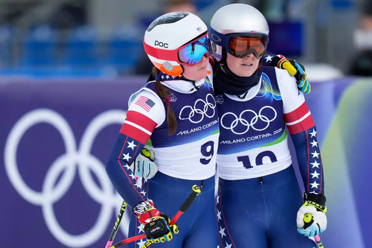 United States' Lindsey Vonn, right, and Breezy Johnson at the finish area during an alpine ski, women's downhill official training, at the 2026 Winter Olympics, in Cortina d'Ampezzo, Italy, Friday, Feb. 6, 2026. (AP Photo/Giovanni Auletta)