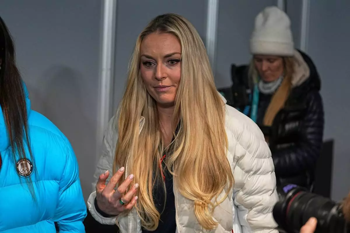 United States' Lindsey Vonn leaves after a press conference by the U.S. ski team at the 2026 Winter Olympics, in Cortina d'Ampezzo, Italy, Tuesday, Feb. 3, 2026. (AP Photo/Fatima Shbair)