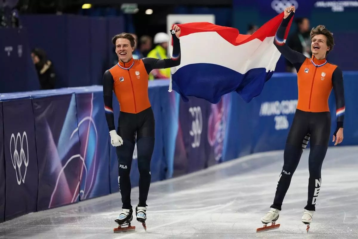 Melle van 't Wout of the Netherlands wins silver, right, and Jens van 't Wout of the Netherlands wins bronze during the short track speed skating men's 500m at the 2026 Winter Olympics, in Milan, Italy, Wednesday, Feb. 18, 2026. (AP Photo/Stephanie Scarbrough)