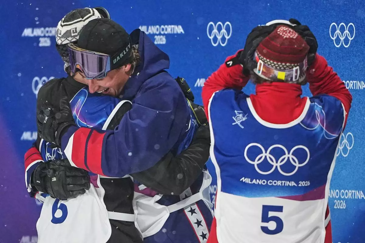 From left, gold medalist Norway's Tormod Frostad, silver medalist United States' Mac Forehand and bronze medalist Austria's Matej Svancer react after the men's freestyle skiing big air finals at the 2026 Winter Olympics, in Livigno, Italy, Tuesday, Feb. 17, 2026. (AP Photo/Lindsey Wasson)
