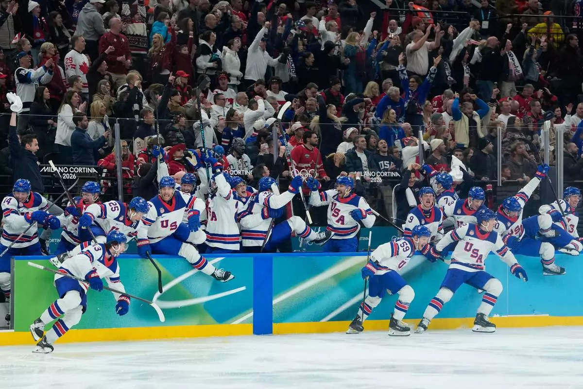 United States players celebrate after defeating Canada in a men's ice hockey gold medal game between Canada and the United States at the 2026 Winter Olympics, in Milan, Italy, Sunday, Feb. 22, 2026. (AP Photo/Petr David Josek)