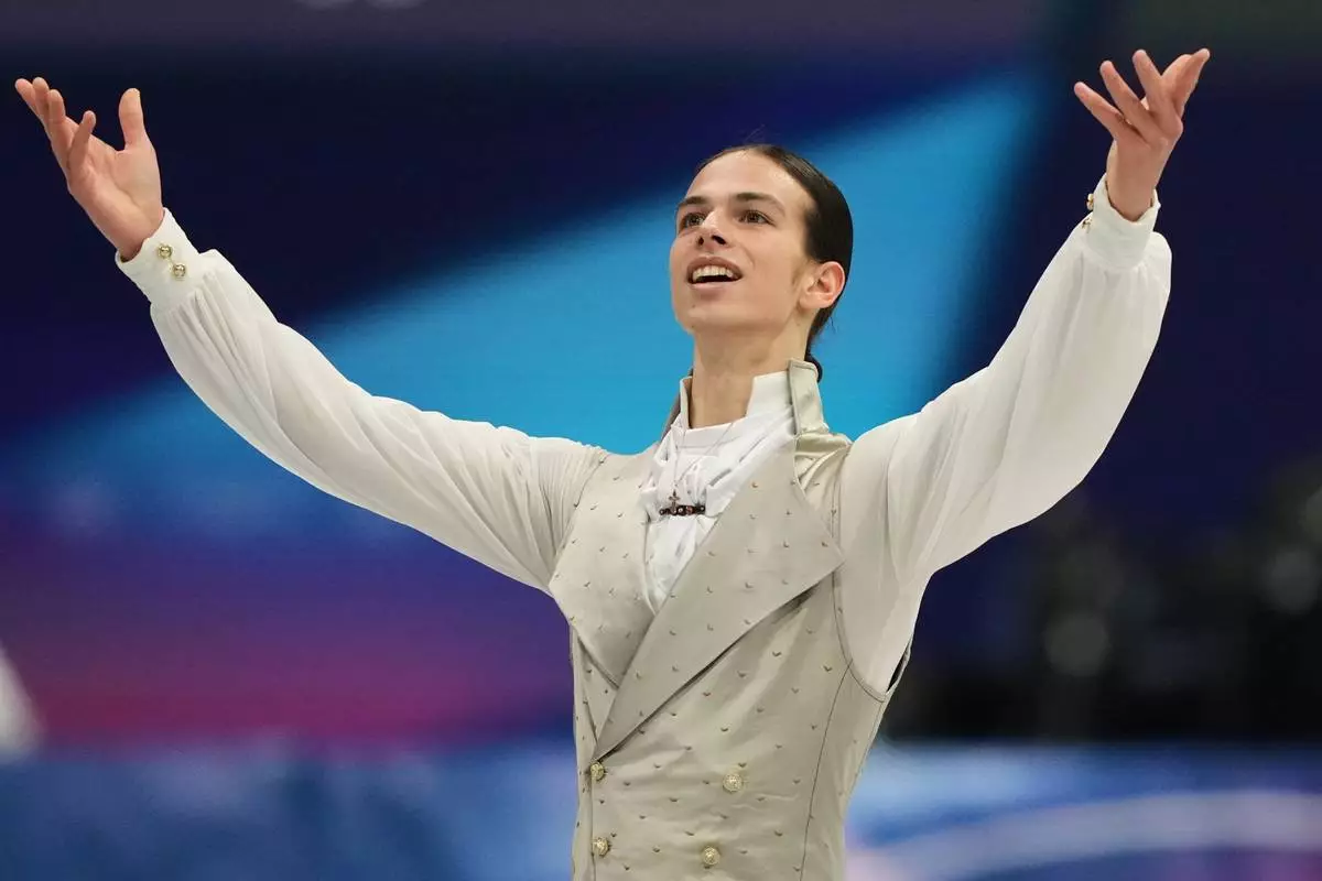 Petr Gumennik of Individual Neutral Athletes competes during the men's free skate program in figure skating at the 2026 Winter Olympics, in Milan, Italy, Friday, Feb. 13, 2026. (AP Photo/Natacha Pisarenko)