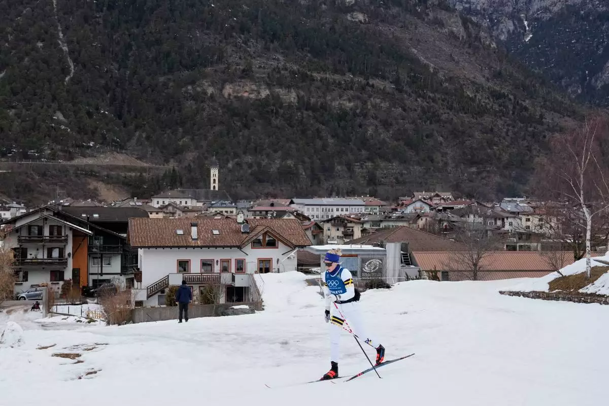 A cross-country skiing athlete from Sweden skis through the village of Ziano di Fiemme during a non-competition day at the 2026 Winter Olympics, near the course in Tesero, Italy, Monday, Feb. 9, 2026. (AP Photo/Armando Franca)