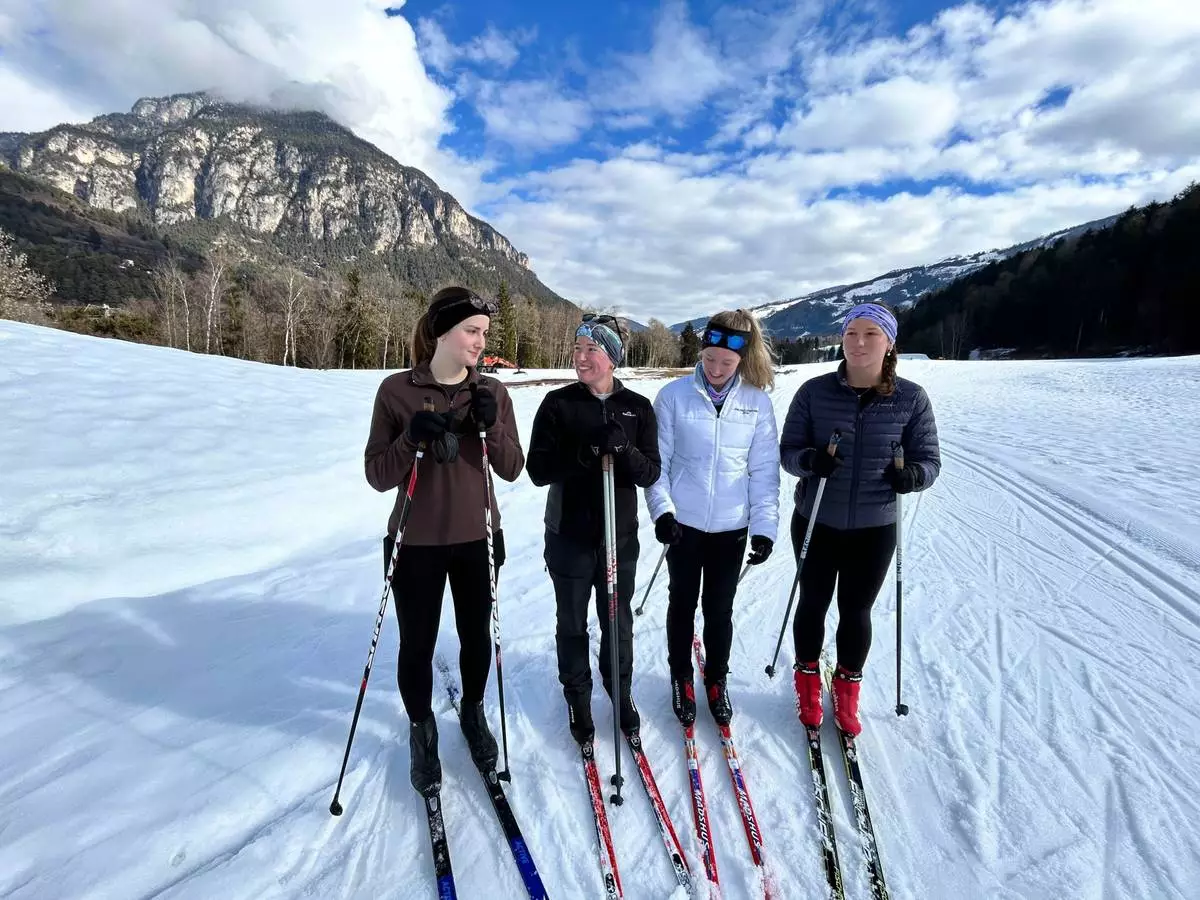 Australians from left, Emma Wilson,Hannah McAdam, Saskia Moon and Kaitlyn Rozic stop while skiing on the Marcialonga trail, during the 2026 Winter Olympics, in Tesero, Italy, Tuesday, Feb. 10, 2026. (AP Photo/Brian Melley)
