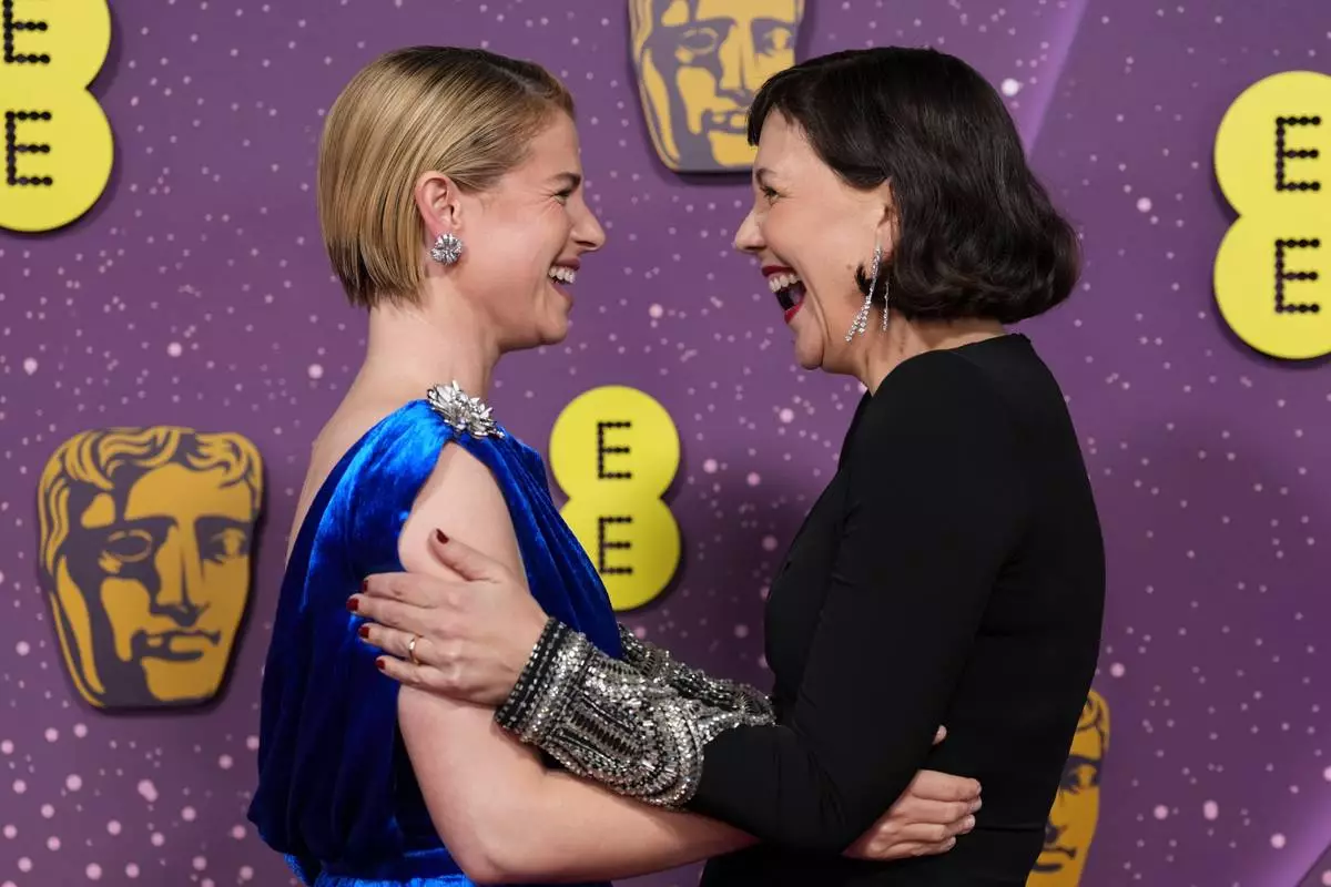 Jessie Buckley, left, and Maggie Gyllenhaal pose for photographers upon arrival at the 79th British Academy Film Awards, BAFTA's, in London, Sunday, Feb. 22, 2026. (AP Photo/Alastair Grant)