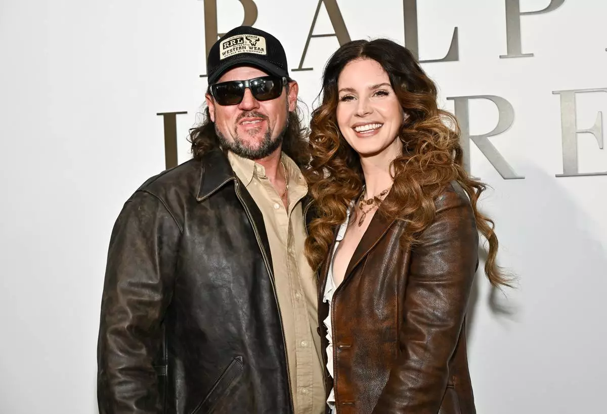 Lana Del Rey, right, and husband Jeremy Dufrene attend the Ralph Lauren Fall/Winter 2026 fashion show as part of New York Fashion Week on Tuesday, Feb. 10, 2026, in New York. (Photo by Evan Agostini/Invision/AP)