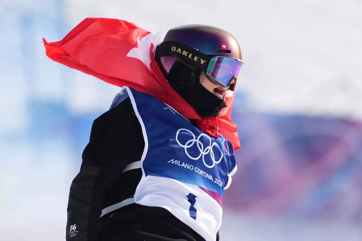 Switzerland's Mathilde Gremaud celebrates her gold medal win in the women's freestyle skiing slopestyle finals at the 2026 Winter Olympics, in Livigno, Italy, Monday, Feb. 9, 2026. (AP Photo/Lindsey Wasson)