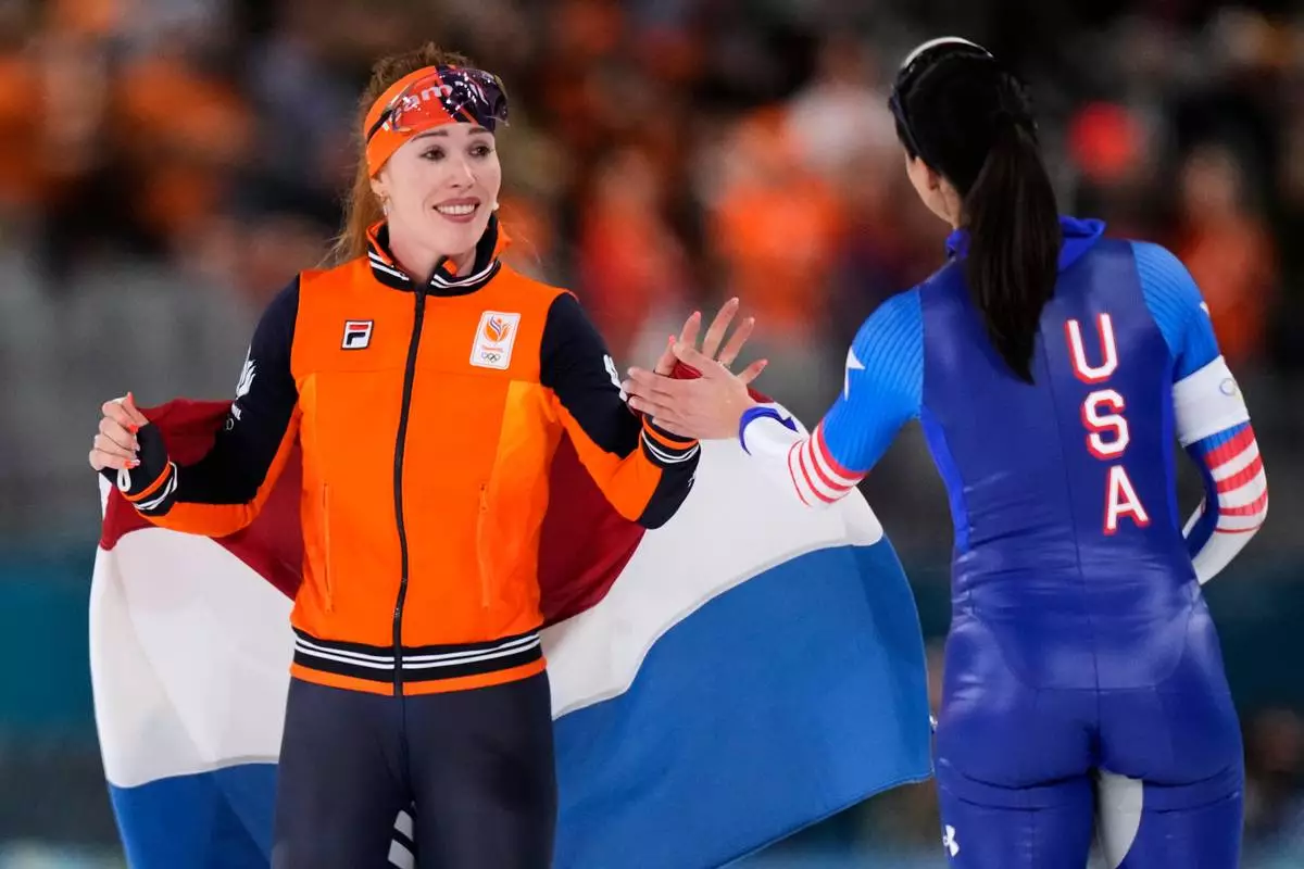 Gold medallist Antoinette Rijpma-de Jong of the Netherlands, left, is congratulated by fourth placed Brittany Bowe of the U.S. after the women's 1500 meters speedskating race at the 2026 Winter Olympics, in Milan, Italy, Friday, Feb. 20, 2026. (AP Photo/Luca Bruno)