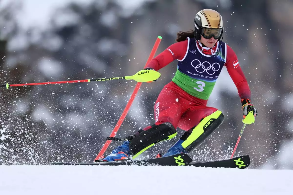 Austria's Katharina Huber speeds down the course during an alpine ski, slalom portion of a women's team combined race, at the 2026 Winter Olympics, in Cortina d'Ampezzo, Italy, Tuesday, Feb. 10, 2026. (AP Photo/Marco Trovati)