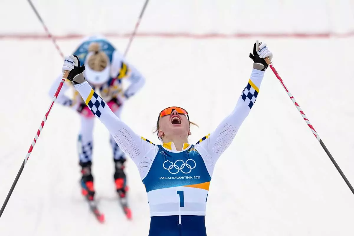 Linn Svahn, of Sweden, crosses the finish line ahead of Jonna Sundling, also of Sweden, to win the gold medal in cross-country skiing women's sprint classic at the 2026 Winter Olympics, in Tesero, Italy, Tuesday, Feb. 10, 2026. (AP Photo/Matthias Schrader)