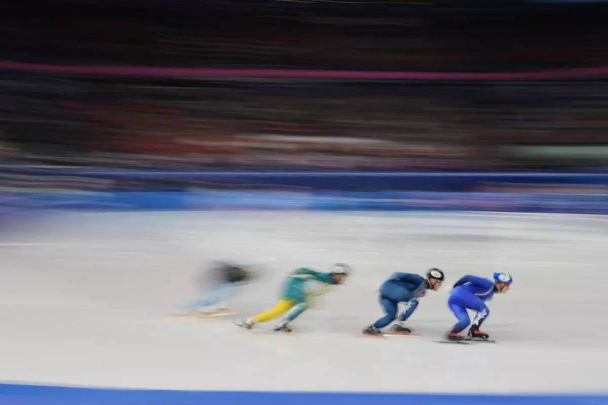 Pietro Sighel of Italy, right, leads his heat while competing in the men's 1000 meter short track speed skating at the 2026 Winter Olympics, in Milan, Italy, Tuesday, Feb. 10, 2026. (AP Photo/Francisco Seco)