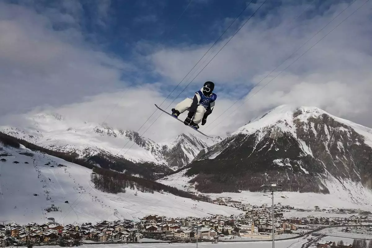 Japan's Ryusei Yamada practices during a snowboarding halfpipe training session at the 2026 Winter Olympics, in Livigno, Italy, Tuesday, Feb. 10, 2026. (AP Photo/Gregory Bull)