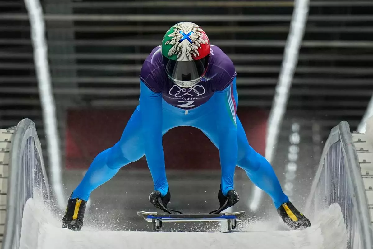 Italy's Amedeo Bagnis arrives at the finish during a men's skeleton training session at the 2026 Winter Olympics, in Cortina d'Ampezzo, Italy, Tuesday, Feb. 10, 2026. (AP Photo/Alessandra Tarantino)