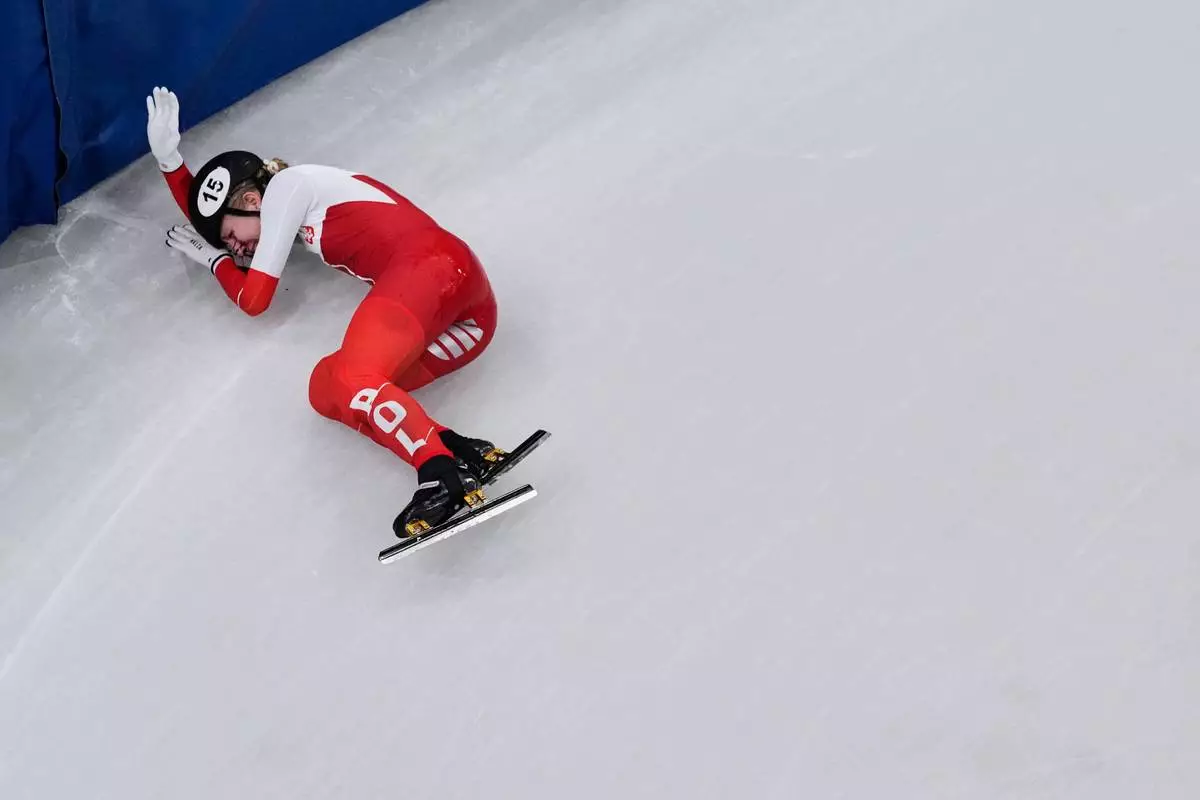 Kamila Sellier of Poland is injured due to a fall during a short track speed skating women's 1500 meters quarterfinal at the 2026 Winter Olympics, in Milan, Italy, Friday, Feb. 20, 2026. (AP Photo/Bernat Armangue)